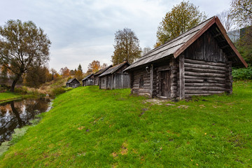 Ancient wooden, blackened by time, houses on the river bank