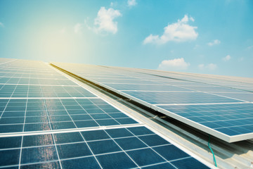 Solar cell in solar farm with green tree and sun lighting reflect, Alternative energy and sustainable energy, photovoltaic, Pure energy Concept. © Anatthaphon