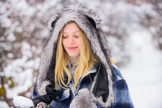 Winter nature background. Sensul girl in fur hat and jacket in wintertime. Fur hat. Cold weather. Winter. Winter fashion. Beautiful stylish woman in winter park. Christmas and new year.