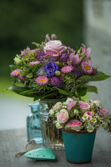 Colorful flower bouquet with little bottles