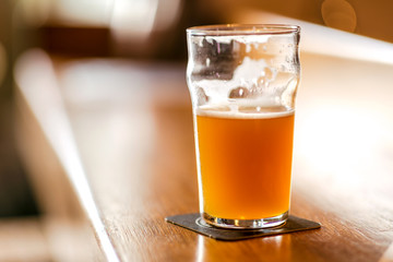 Glass of unfiltered beer in a brewery