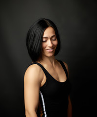 Fototapeta na wymiar portrait of a beautiful young woman with black hair on a dark background