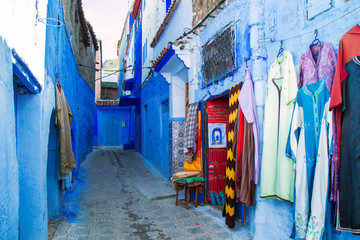 Obraz na płótnie Canvas Traditional carpets on the blue Chefchaouen street.