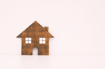 Obraz na płótnie Canvas A little flat wooden house on the white background