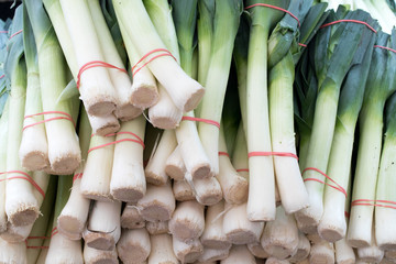 bunches of leeks in a famer's market stall