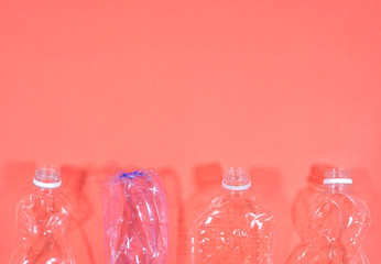 Plastic bottles isolated on pink background. Seamless pattern. Recycle waste management concept. Plastic Pet Bottles. Copy space