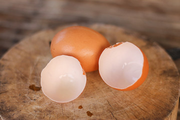 Brown eggs with egg shells on a wooden chopping board On the bamboo battens.
