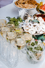 buffet table with wine and juice, fruits and sweets, snacks and mint ice