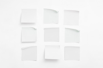 Set of white sheets of paper for notes with curled corners. Empty colorless stickers square shape