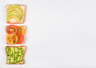 Set with toast bread and different toppings on white background, top view