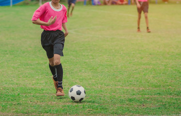 Training and football match between youth soccer teams in school.