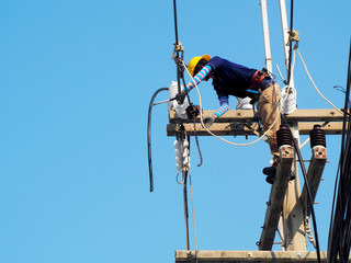 electrician man working at height and dangerous ,high voltage power line maintenance
