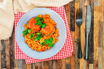 stuffed tomatoes with rice on a white plate