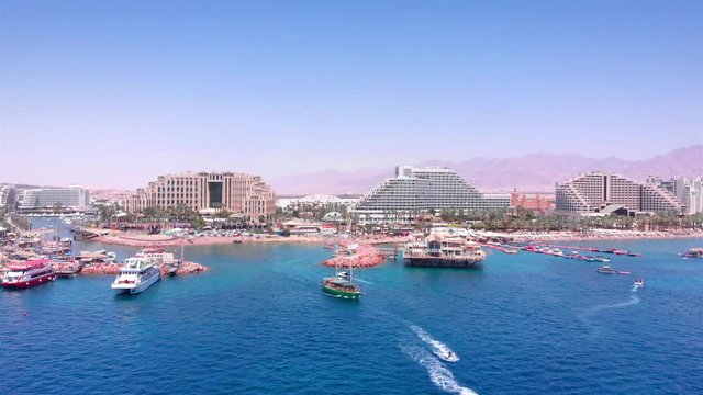 Boats in the red sea With Eilat City in the background Aerial Drone footage over Red sea with boats And Eilat city in the backgroud