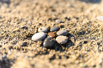 Fototapeta na wymiar arrangement of colored sea stones and sand