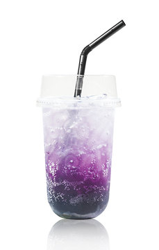 Blueberry italian soda drink in glass with straws.