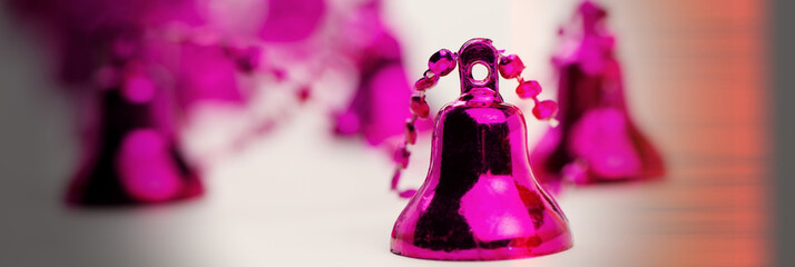 Christmas tree toy purple bell on a light background.