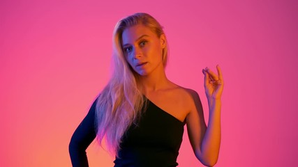 Neon lights vivid colors concept model isolated. Young attractive woman shows blah blah blah gesture with her hand. Beautiful girl and useless conversation in modern life