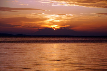 Evening in September. Sunset. Ship silhouette on the horizon. Beautiful view . Greece Sithonia Aegean Sea. Skyline. Horizon. Sky clouds. The setting sun