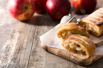 Traditional homemade apple strudel on wooden table. Copy space