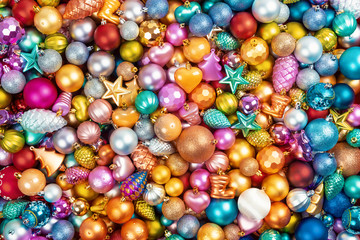 Many multi-colored christmas toys background texture. Top view.