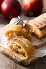Traditional homemade apple strudel on wooden table