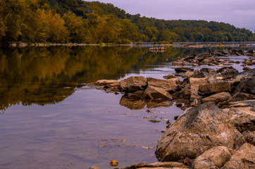 Potomac river flowing through the rocks on moody autumn morning in Virginia near DC