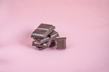 Chocolate stack on pink background.
