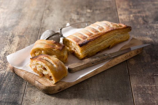 Traditional homemade apple strudel on wooden table