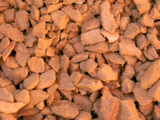 Instant coffee. Macrophotography. Texture, texture. Bits and pieces. Brown background.