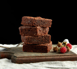 stack of baked square pieces of chocolate brownie cake