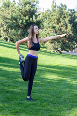 Fitness. Athlete girl, thlete exercise at outside, woman fitness. Young Beautiful Woman Stretching In The Park.