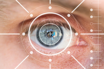 Close up of man eye in process of scanning, monitoring. Face ID and scanning concept.
