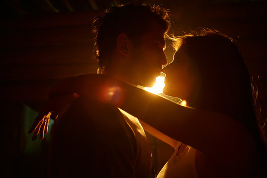 young couple in love. Kissing man and woman at home in intimate atmosphere.
