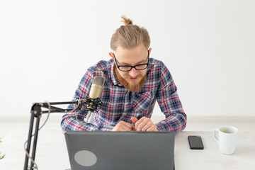 Radio host concept - Handsome man working as radio host at radio station