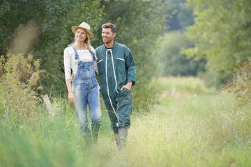 Couple of farmers walking in field