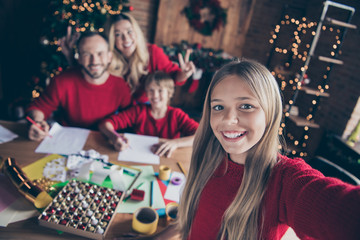 Fototapeta premium Photo of big family parents sister brother spending x-mas eve together writing santa claus wish letter shooting selfies sitting table indoors wear red jumpers