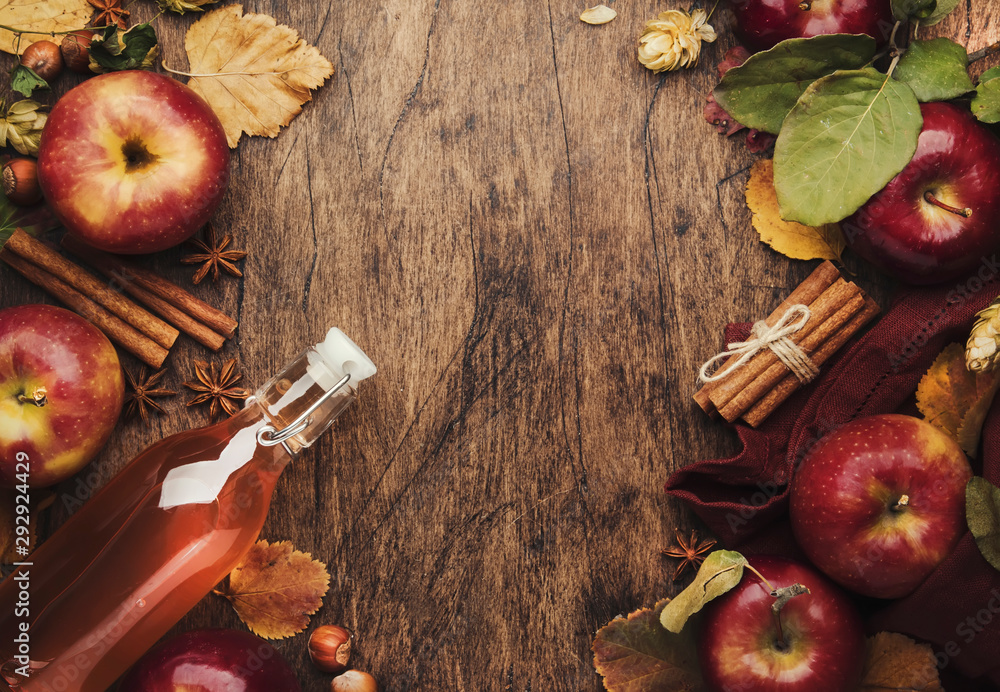 Wall mural apple cider vinegar. bottle of fresh apple organic vinegar on wooden table background with cinnamon 