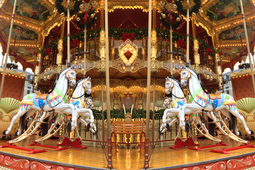 festive merry-go-round carousel with horses and lights in Frankfurt during the Christmas market,...