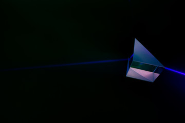 Laser beam and optical glass on black background