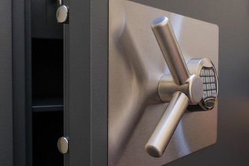 Open door of a safe with a digital code lock.