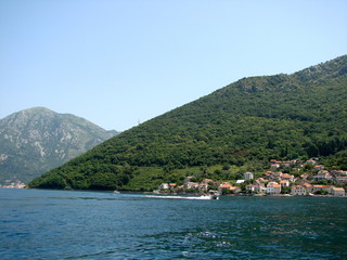 Landscape from the sea of ​​small Montenegrin seaside settlements near the azure bay surrounded...