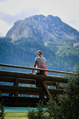 Naklejka premium Hiking Woman in front of Mountain Landscape