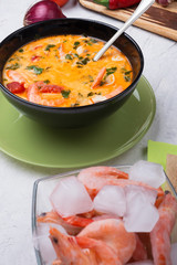 famous delicious Thai Tom yum spicy soup with shrimps  on white table. close up