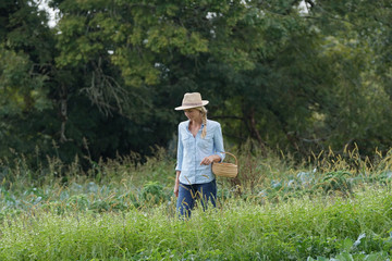 Farmer woman walking in agricultural field