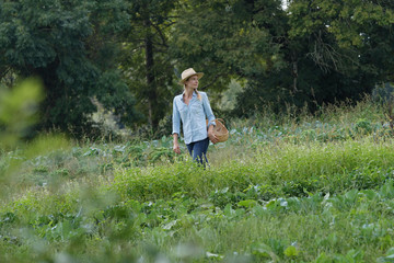 Farmer woman walking in agricultural field