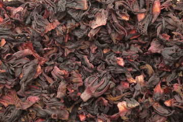 Dried red hibiscus flowers close up.