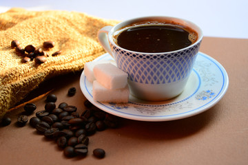 cup of coffee and cookies on table