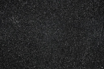 Fototapeta premium Abstract black shiny background, pattern. Dark sparkle texture, backdrop. Material, paper design. Glowing tinsel.