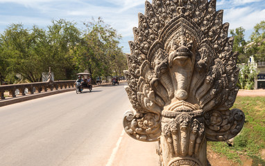 Fototapeta na wymiar The perspective of an old angkor bridge road with stone statue in Siem Reap, Cambodia